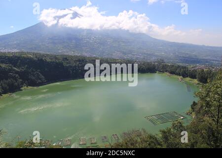 the beauty of Menjer Lake against the background of Mount Sindoro. tourist destination 'Hill of Love, Seroja Valley' Wonosobo, Central Java. Stock Photo