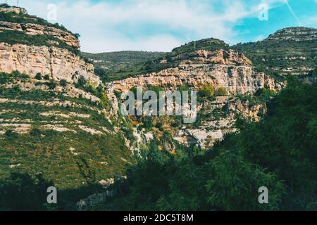 Landscape of some imposing rugged mountains illuminated by sunlight Stock Photo