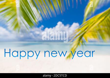 Happy new year written in the sky. Artistic summer beach holiday with new years eve concept Stock Photo