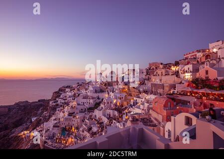 Oia town cityscape at Santorini island in Greece. Stunning sunset landscape seascape, tranquil, relaxing summer romance, couple vacation destination Stock Photo