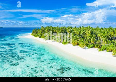 Aerial photo of beautiful Maldives paradise tropical beach. Amazing view, blue turquoise lagoon water, palm trees and white sandy beach. Luxury travel