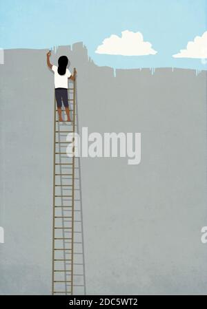 Woman on ladder painting blue sky over gray wall Stock Photo