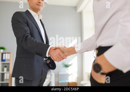 Cropped image of two business people shaking hands to confirm their partnership. Stock Photo