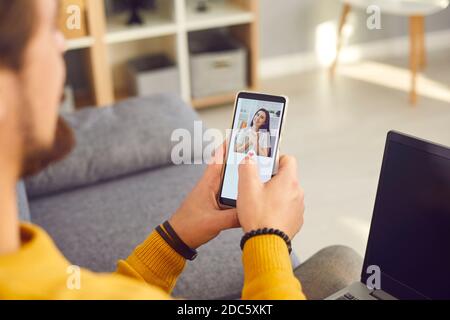 Single young man using a modern mobile dating application to look for a girlfriend Stock Photo