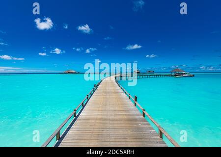 Panorama of water villas bungalows at tropical beach in the Maldives at summer day. Luxury summer travel landscape, seascape. Shades of blue in tropic Stock Photo