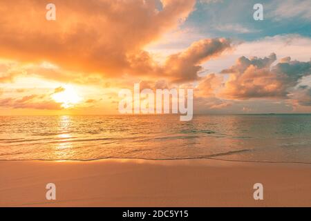 Tropical vacation landscape. Seascape with blue cloudy sky. Closeup of sand on beach and blue summer sky. Panoramic beach landscape. Inspirational Stock Photo