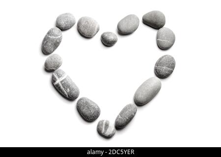 Pebbles on white background, sea pebble. Symbol in the form of heart. The concept of passion for beach rest and travel Stock Photo