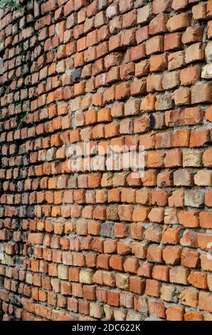 Geometric composition of rectangular clay bricks. Red brick wall weathered. Multitasking background. Without anyone. Stock Photo