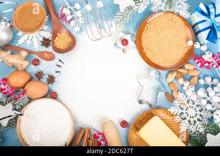 Christmas gingerbread cookies cooking background flat lay top view template with copy space for text. Baking utensils, spices and food ingredients on Stock Photo