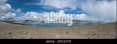 Panorama Karakul Lake with mountains and view on high snowy mountains, desert and valley in Tajikistan. Stock Photo