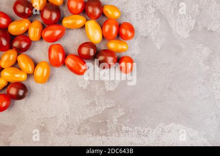 Cherry tomatoes on gray marble background. Copyspace. Stock Photo