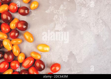 Cherry tomatoes on gray marble background. Copyspace. Stock Photo