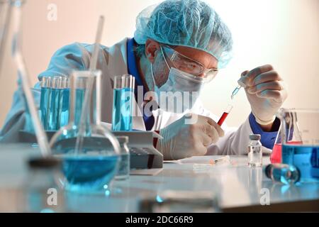 Microbiologist mixing reagent with sample in laboratory. Horizontal composition. Front view. Stock Photo
