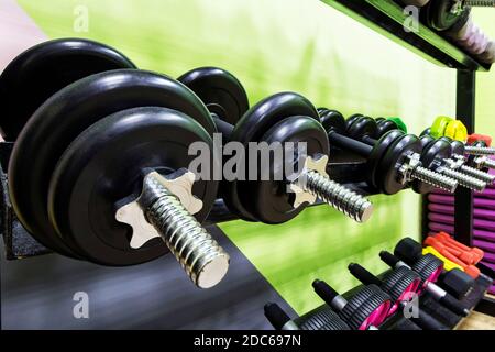 dumbbell set close-up on rack in sport fitness gym center workout training and concept healthy sport equipment and tool theme Stock Photo