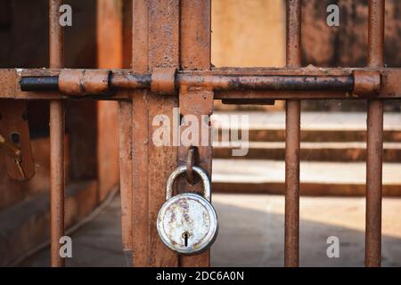 Old rusted metal door with latch and padlock Stock Photo