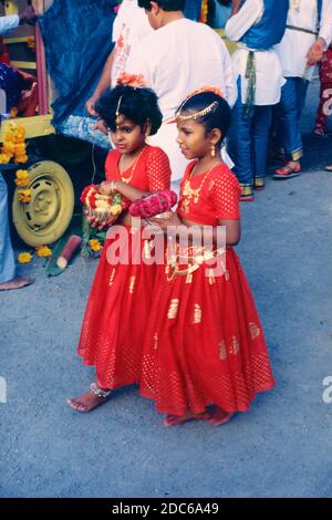 Young Indian or Hindu Girls Dressed in Traditional Dress & Carrying Offerings for Diwali, the Hindu Festival of Lights, in Reunion Island France Stock Photo