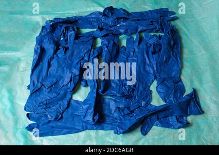 Blue gloves piled on green sanitary cloth.   Hand and arm protection. Stock Photo