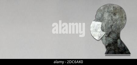 An abstract black and white of a bust of a man wearing a surgical mask on a textured background. Medical concept and horizontal image. Stock Photo