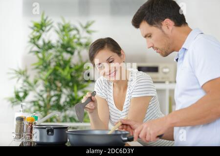 beautiful couple cooking in the kitchen Stock Photo