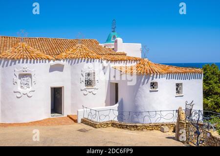 Porto Cervo, Sardinia / Italy - 2019/07/20: Chiesa Stella Maris church overlooking port and residences of Porto Cervo resort at the Costa Smeralda coa Stock Photo