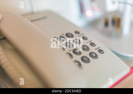 Close up soft focus on telephone devices at office desk with light effect, communication technology concept Stock Photo