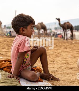 a little rajasthani boy is crying at camel fair of pushkar. Stock Photo