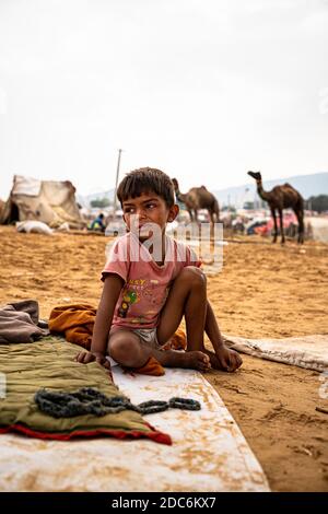 a little rajasthani boy is crying at camel fair of pushkar. Stock Photo