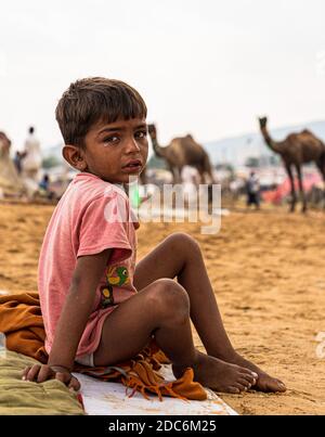 a little rajasthani boy is crying at pushkar camel fair. Stock Photo