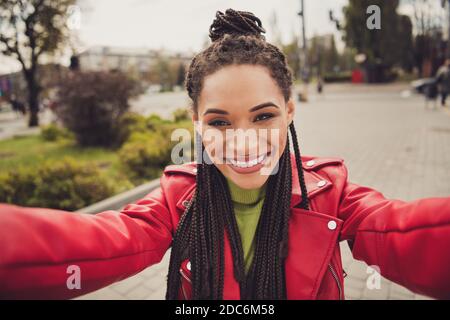 Photo of young afro woman happy positive smile make self photo selfie shooting blogger wear leather jacket Stock Photo
