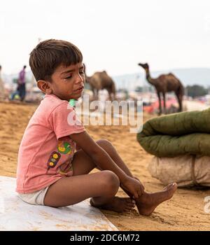 a little rajasthani boy is crying at pushkar camel festival of rajasthan. Stock Photo