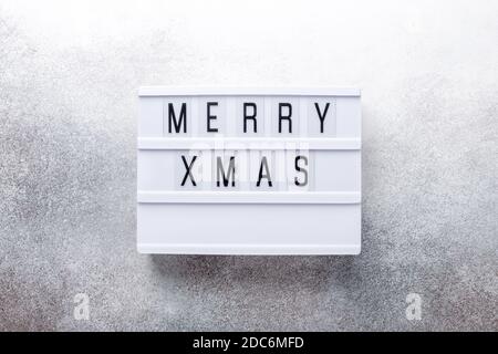 Lightbox with text MERRY XMAS on stone background - Image Stock Photo