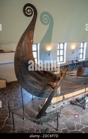 Oslo, Ostlandet / Norway - 2019/08/31: Oseberg ship excavated from ship burial archeological site, exhibited in Viking Ship Museum on Bygdoy peninsula Stock Photo