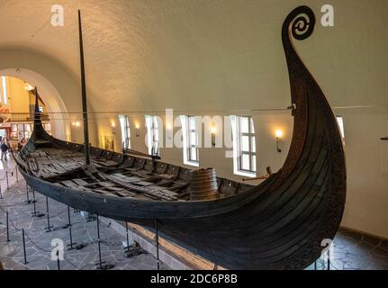 Oslo, Ostlandet / Norway - 2019/08/31: Oseberg ship excavated from ship burial archeological site, exhibited in Viking Ship Museum on Bygdoy peninsula Stock Photo