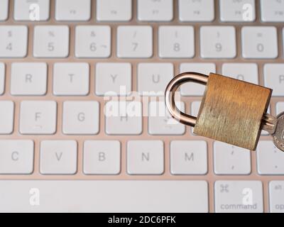 A top view of a padlock on a keyboard, internet security concept Stock Photo