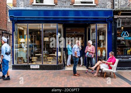 Local People Outside An Antiques Shop In The High Street, Lewes, East Sussex, UK. Stock Photo