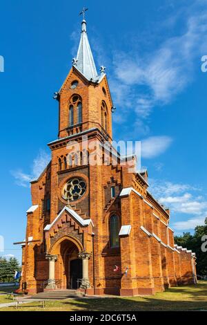 Naglowice, Swietokrzyskie / Poland - 2020/08/16: Neo-gothic parish church of St. Mary Rosary near park and historic museum manor house of Mikolaj Rej, Stock Photo