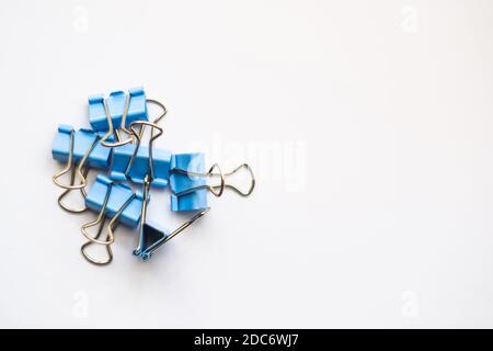 Colored iron paper clips. paper clips with many unique pastel color variants isolated on a white background, Binder clip is a simple device for bindin Stock Photo