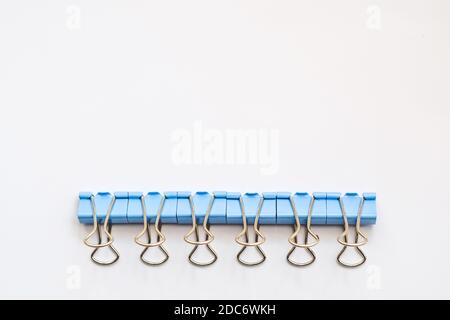 Colored iron paper clips. paper clips with many unique pastel color variants isolated on a white background, Binder clip is a simple device for bindin Stock Photo