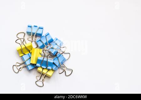 Colored iron paper clips. paper clips with many unique pastel color variants isolated on a white background, Binder clip is a simple device for bindin Stock Photo