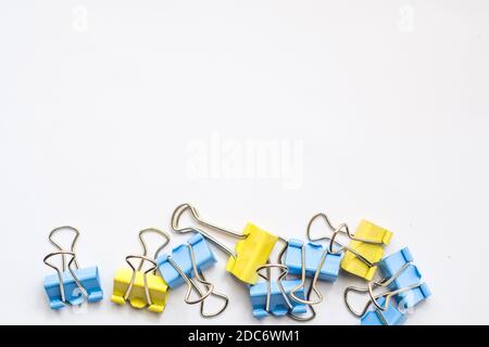 Colored iron paper clips. paper clips with many unique pastel color variants isolated on a white background, Binder clip is a simple device for bindin Stock Photo