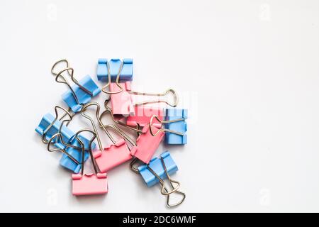 Colored iron paper clips. paper clips with many unique pastel color variants isolated on a white background, Binder clip is a simple device for bindin Stock Photo