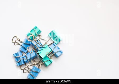Colored iron paper clips. paper clips with many unique pastel color variants isolated on a white background, Binder clip is a simple device for bindin Stock Photo