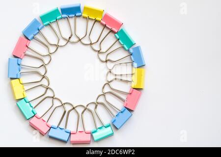 Colored iron paper clips. paper clips with many unique pastel color variants isolated on a white background, Binder clip is a simple device for bindin Stock Photo