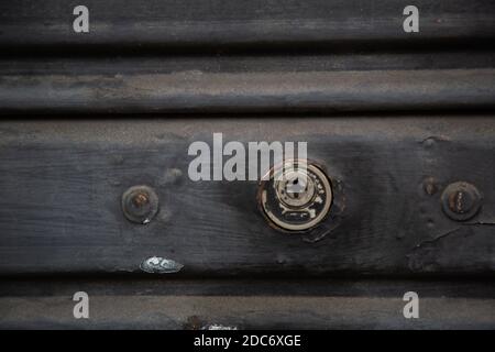 A closeup shot of an old weathered metal keyhole Stock Photo