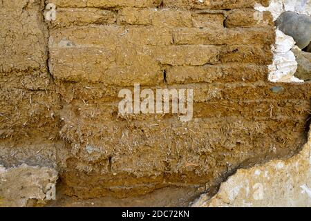 Old handmade clay and straw mud bricks exposed in wall Stock Photo