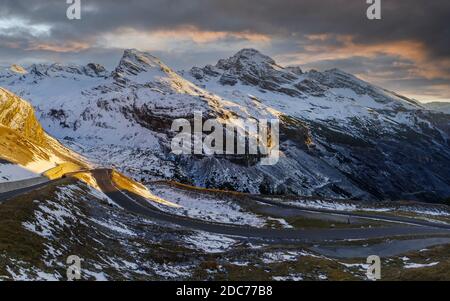 View of the road SS 38 leading to Stelvio mountain pass and mountain range in the background in Lombardy, Italy Stock Photo