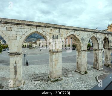 SULMONA, ITALY - september 27 2020: cityscape with monumental arcade of medieval Swabian acqueduct at historical town, shot in bright cloudy light  on Stock Photo