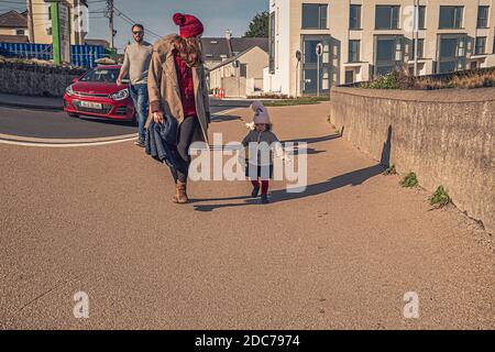 Childhood. Girl playing with mummy shadow in sunny day. Stock Photo