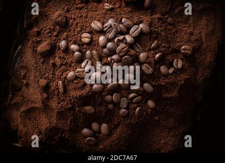 A pile of ground coffee with coffee beans on top Stock Photo