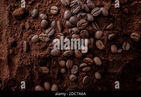 A pile of ground coffee with coffee beans on top Stock Photo